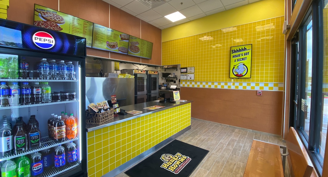 Hungry Howie’s Keller location storefront, showcasing their soda freezer and checkout counter. Hungry Howie's Keller location storefront, showcasing their soda freezer and checkout counter.