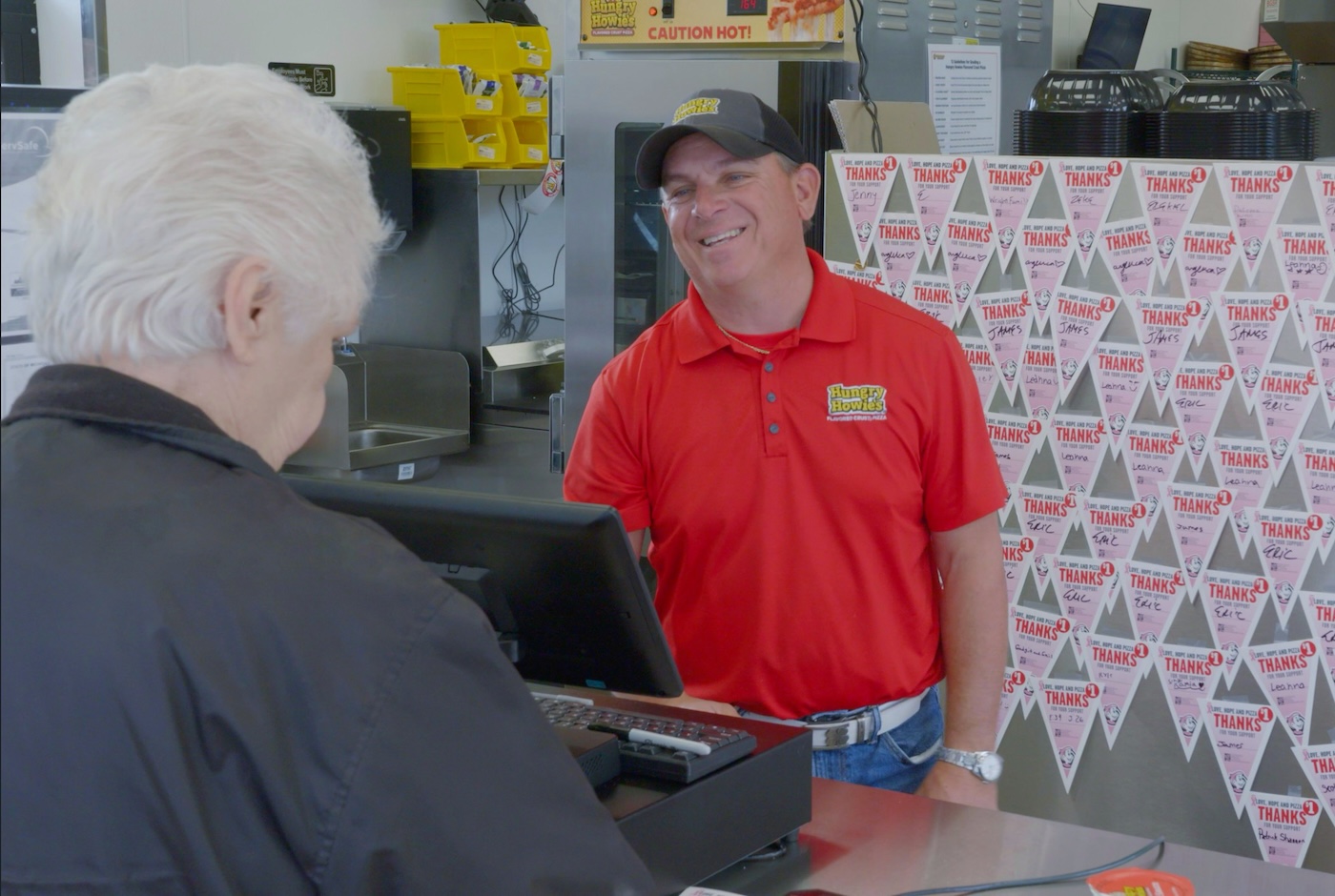 Franchise owner smiling at a customer