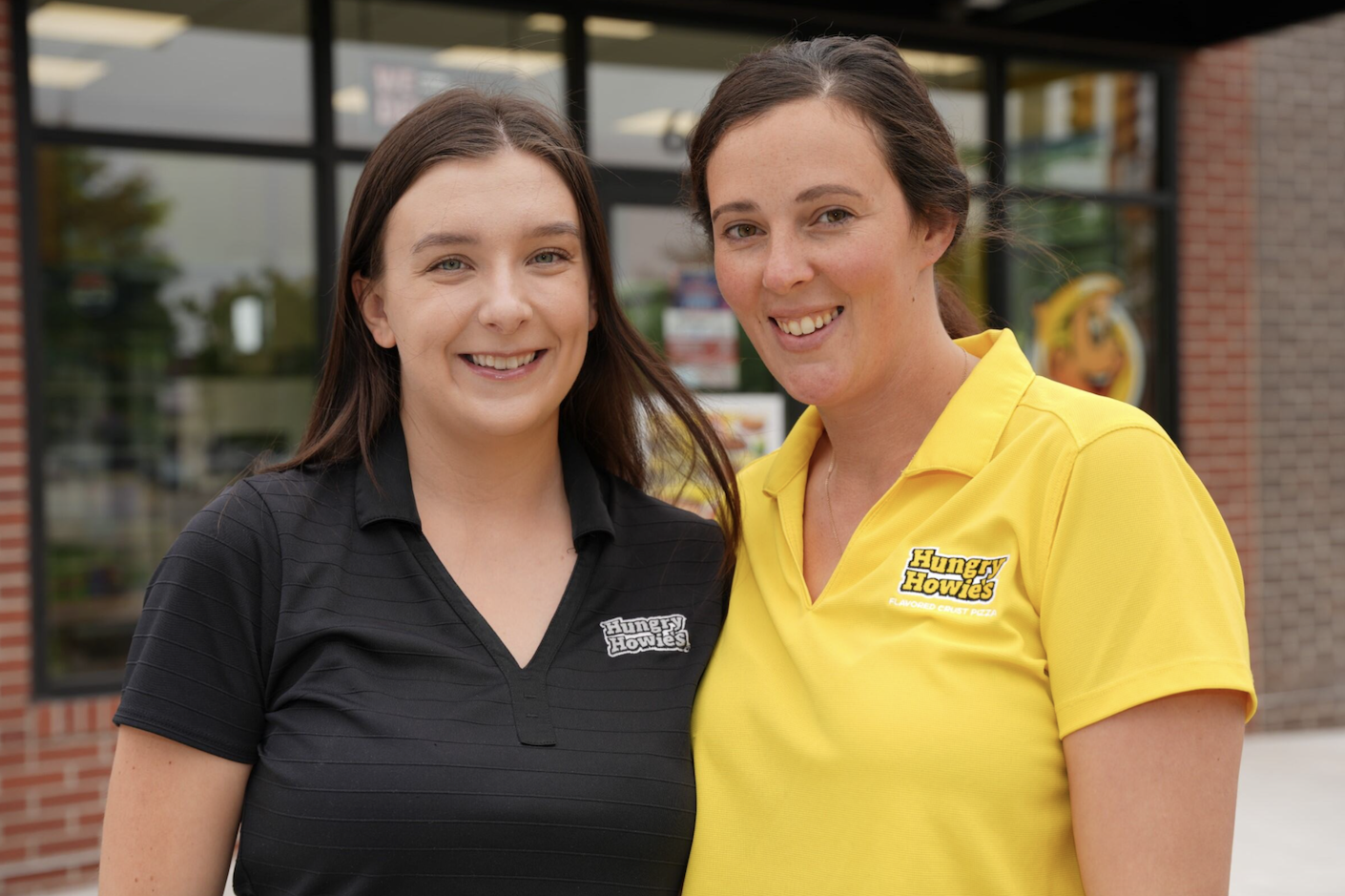 Two smiling Hungry Howie's franchise owners