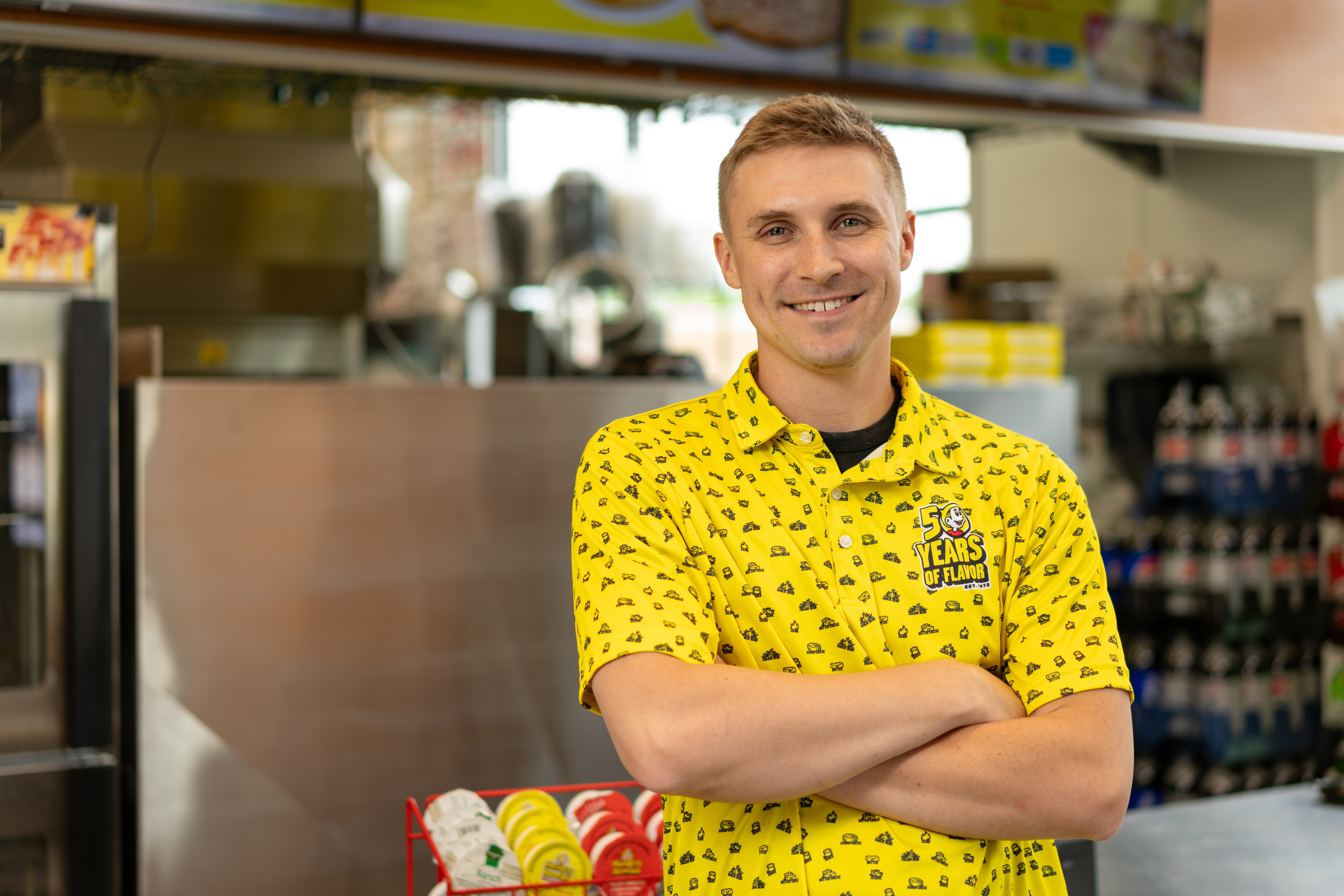 Hungry Howie's employee standing in front of the register
