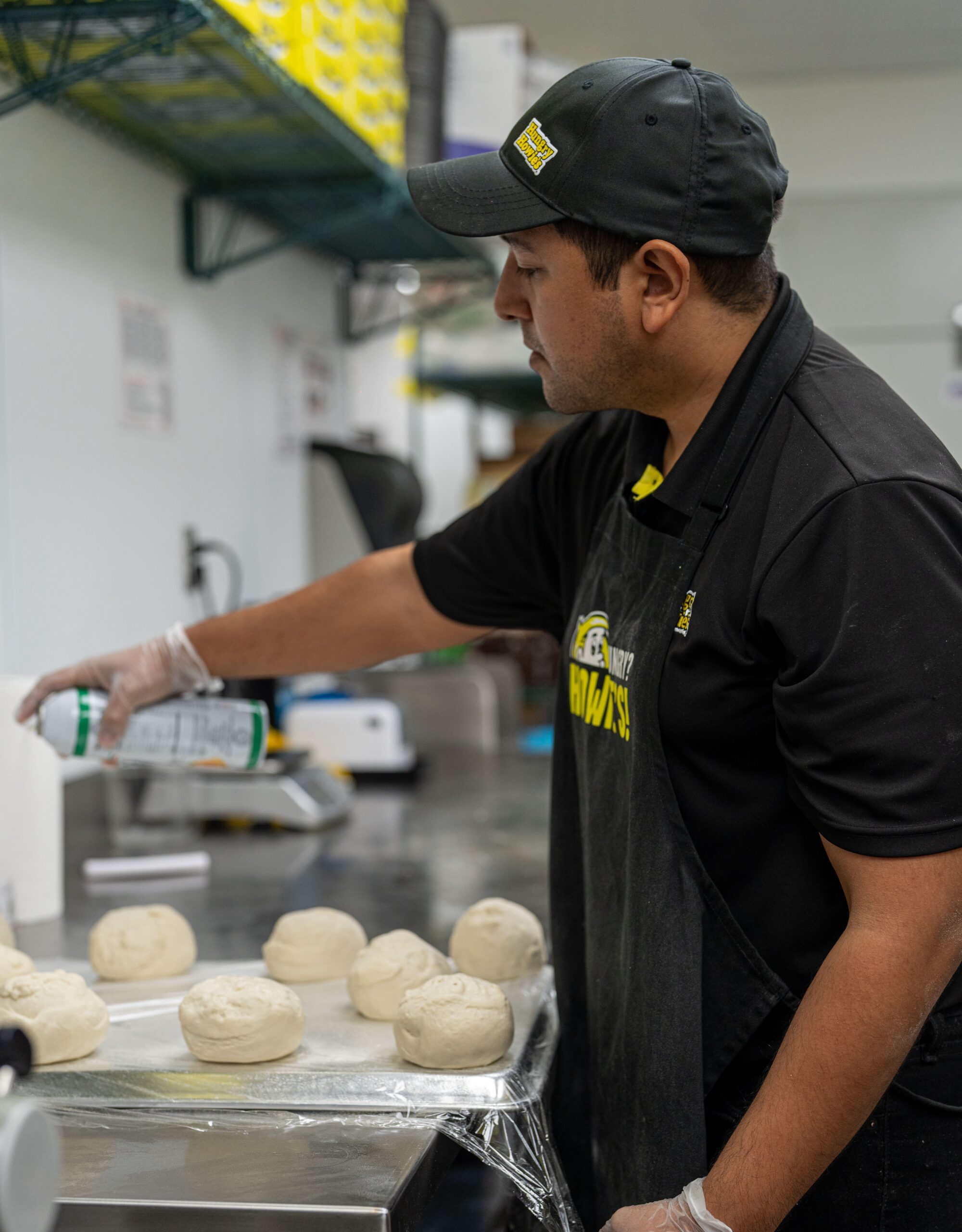 Hungry Howie’s employee in the kitchen making pizza dough Hungry Howie's employee in the kitchen making pizza dough