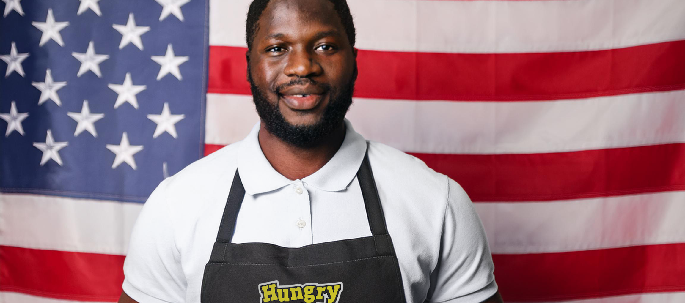 Portrait of a veteran standing in front of the American flag with a hungry howie’s black apron on. Portrait of a veteran standing in front of the American flag with a hungry howie's black apron on.