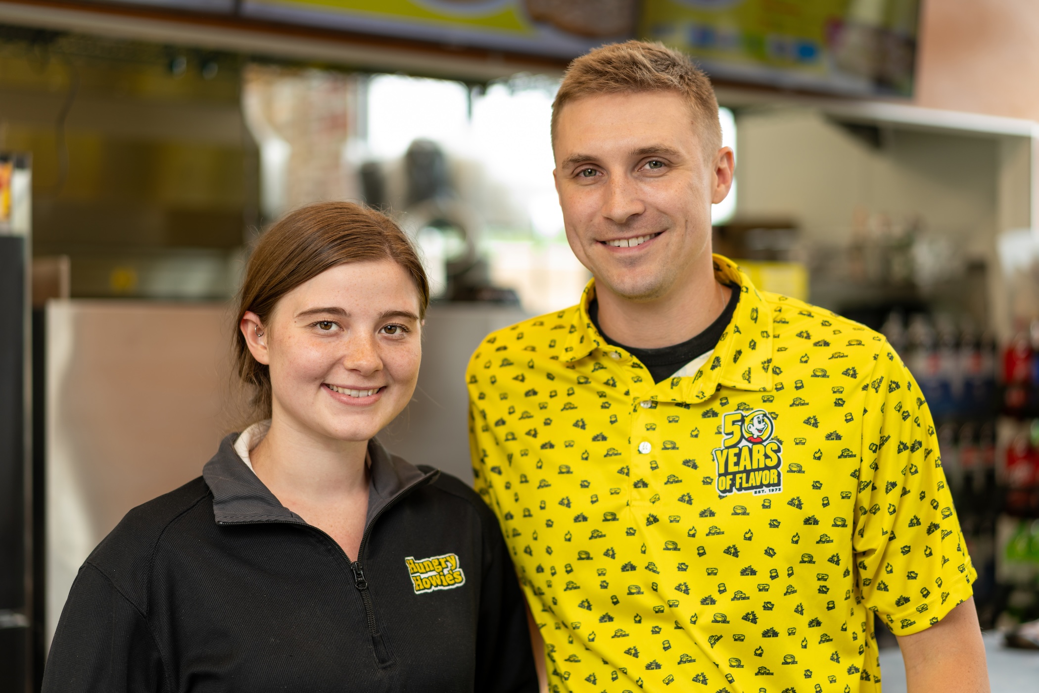 Two smiling hungry howie's employees