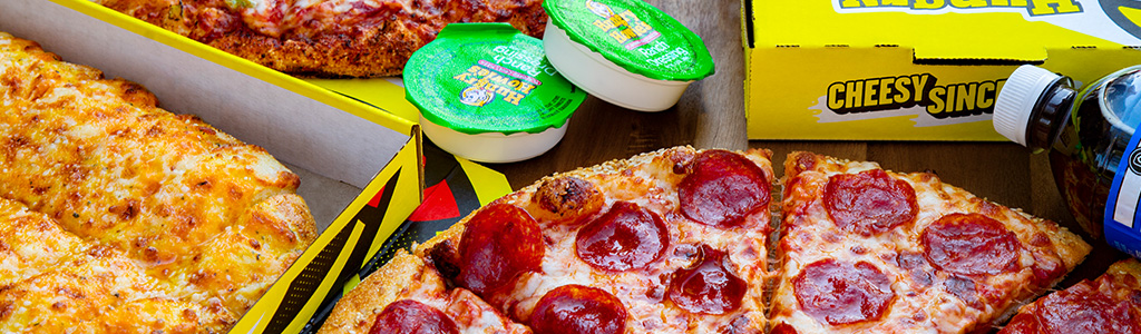 Close up of a pepperoni pizza and cheese sticks