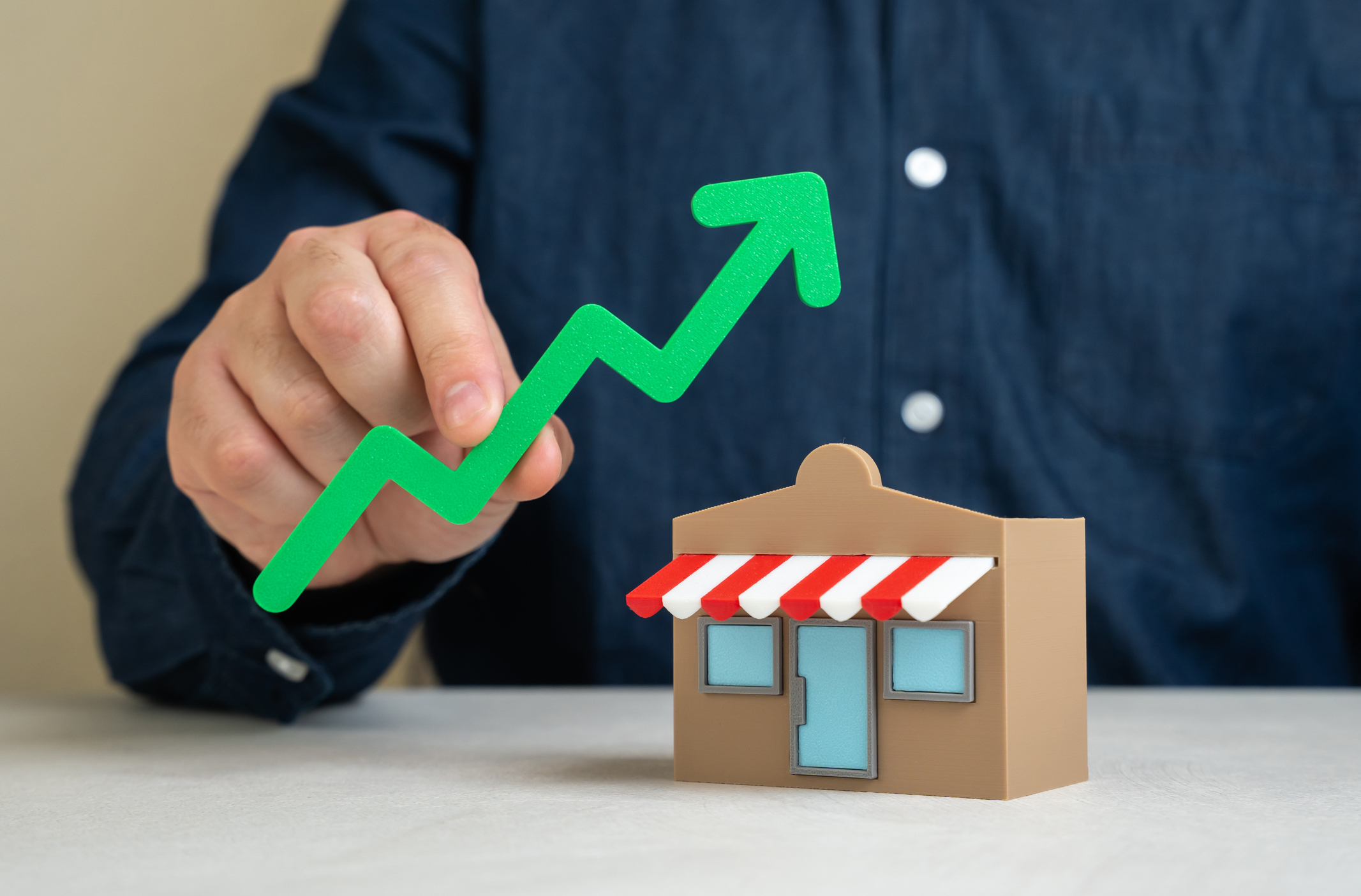 Shop and green arrow up. Business growth and expansion. Upward business momentum Shop and green arrow up. Business growth and expansion. Upward business momentum, rising profits, and market presence. Successful entrepreneurship, customer demand, brand scalability